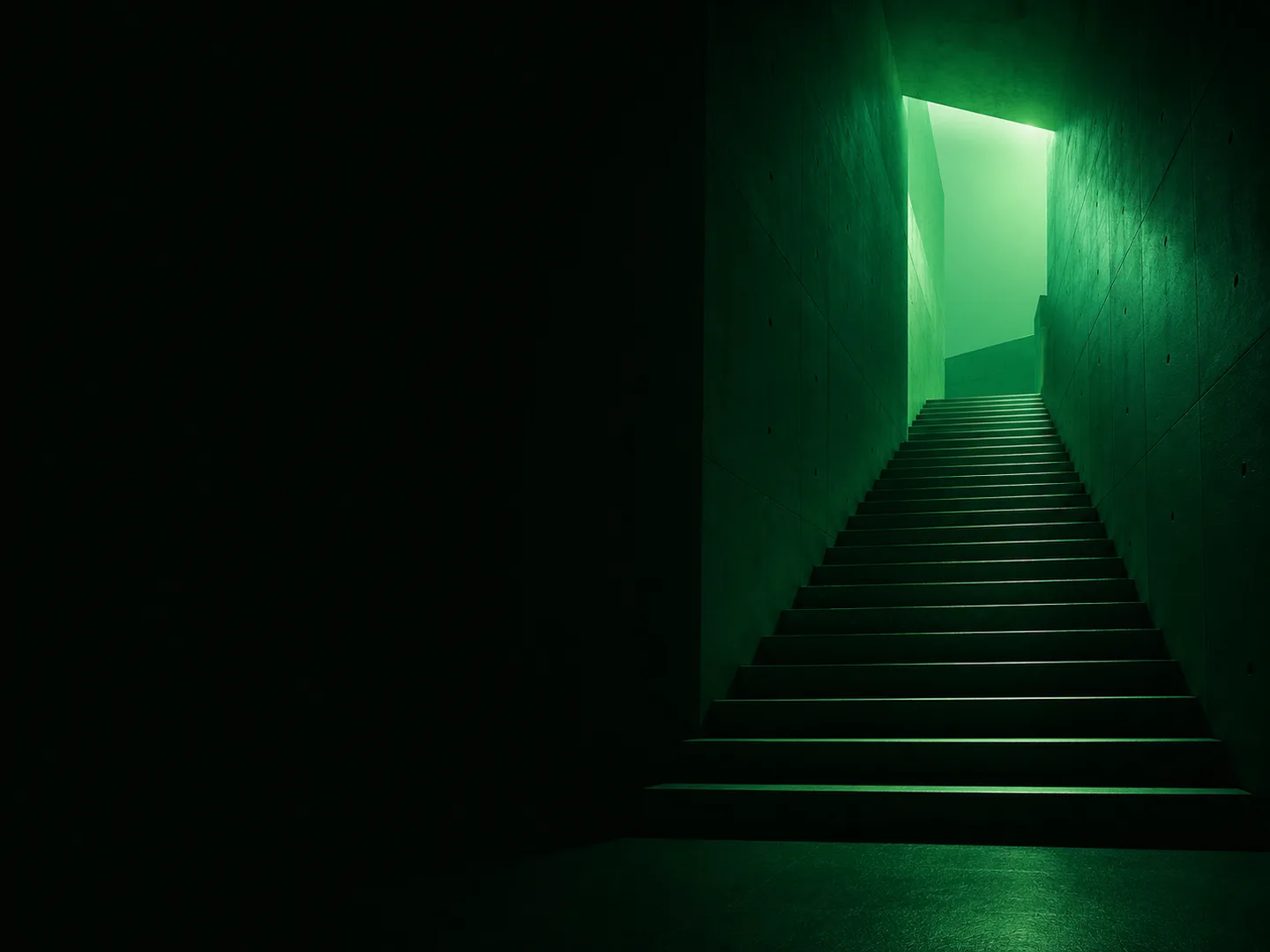 Concrete staircase ascending toward green light